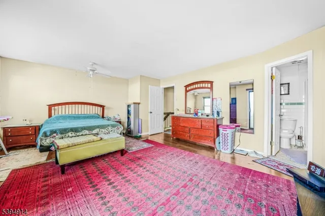 a bedroom with a bed and a view of living room