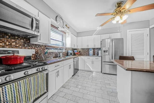 a kitchen with appliances cabinets and a sink