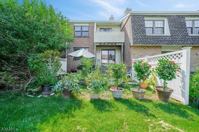 a aerial view of a house with swimming pool next to a yard
