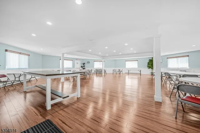 a view of a living room or kitchen and a wooden floor