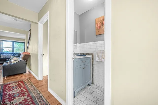 a hallway with cabinets and wooden floor