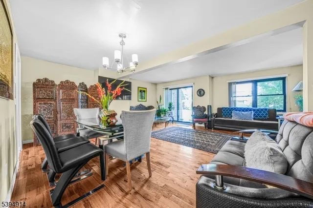 a living room with furniture chandelier and a table