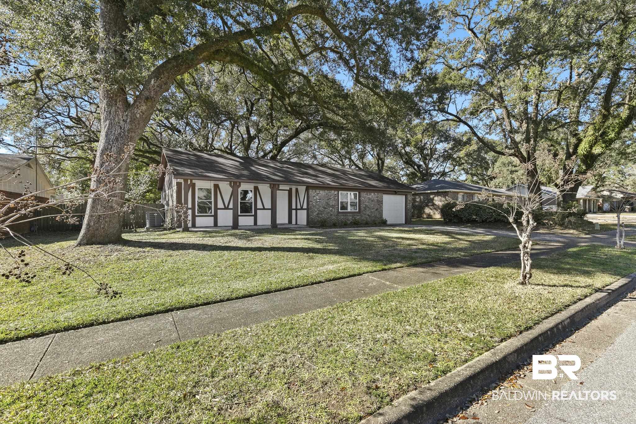 5817 Woodgate Road Mobile, AL 36609 - Photo 76 of 85 View of front of house with a garage, driveway, and a front yard