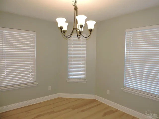 a view of a room with wooden floor and windows
