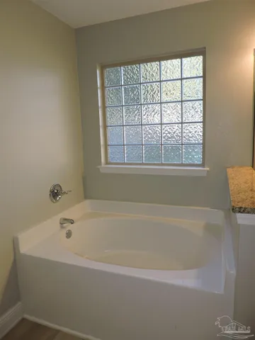 a white bath tub sitting next to a window