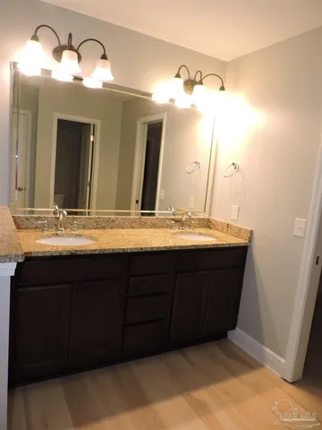 a bathroom with a double vanity sink and a mirror