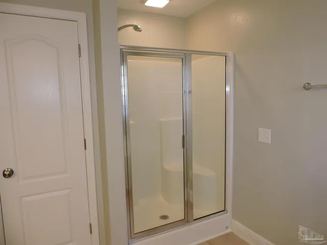 a bathroom with a glass shower door