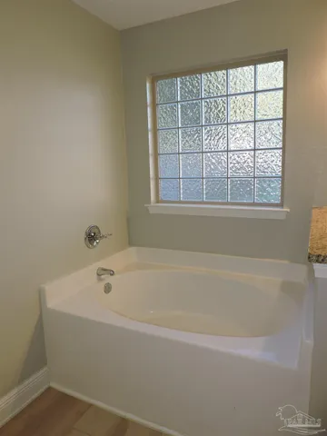 a white bath tub sitting next to a window