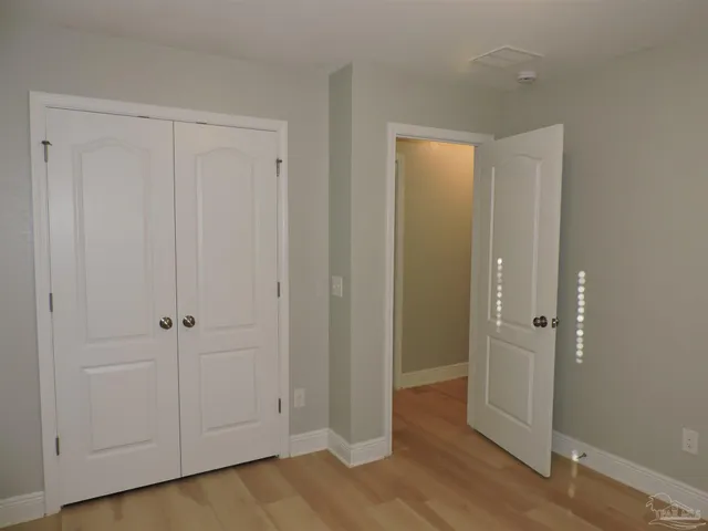 an empty room with wooden floor