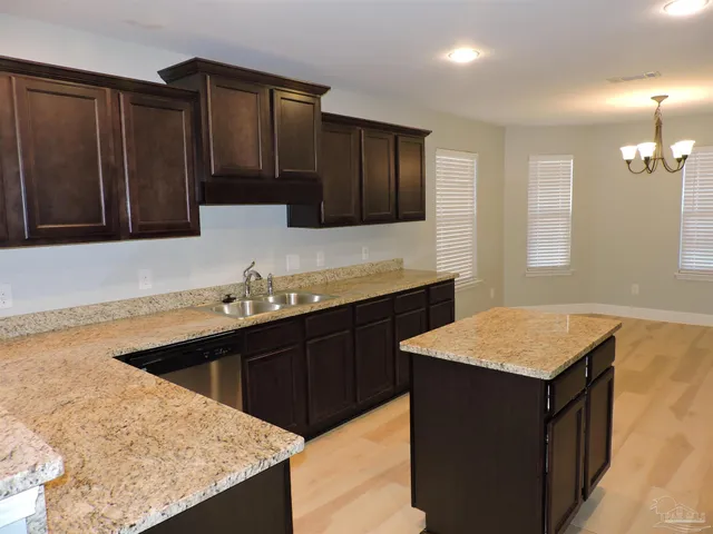 a kitchen with a sink a stove and cabinets