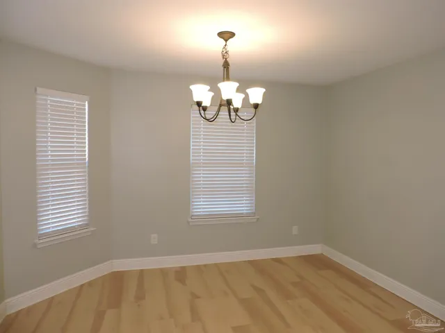 a view of a room with a window and chandelier