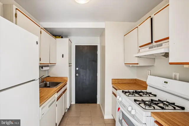 a kitchen with stainless steel appliances granite countertop a refrigerator and a stove