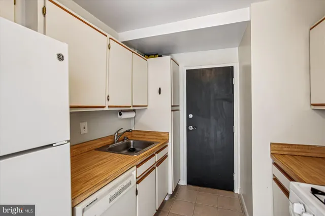 a kitchen with a sink and a refrigerator