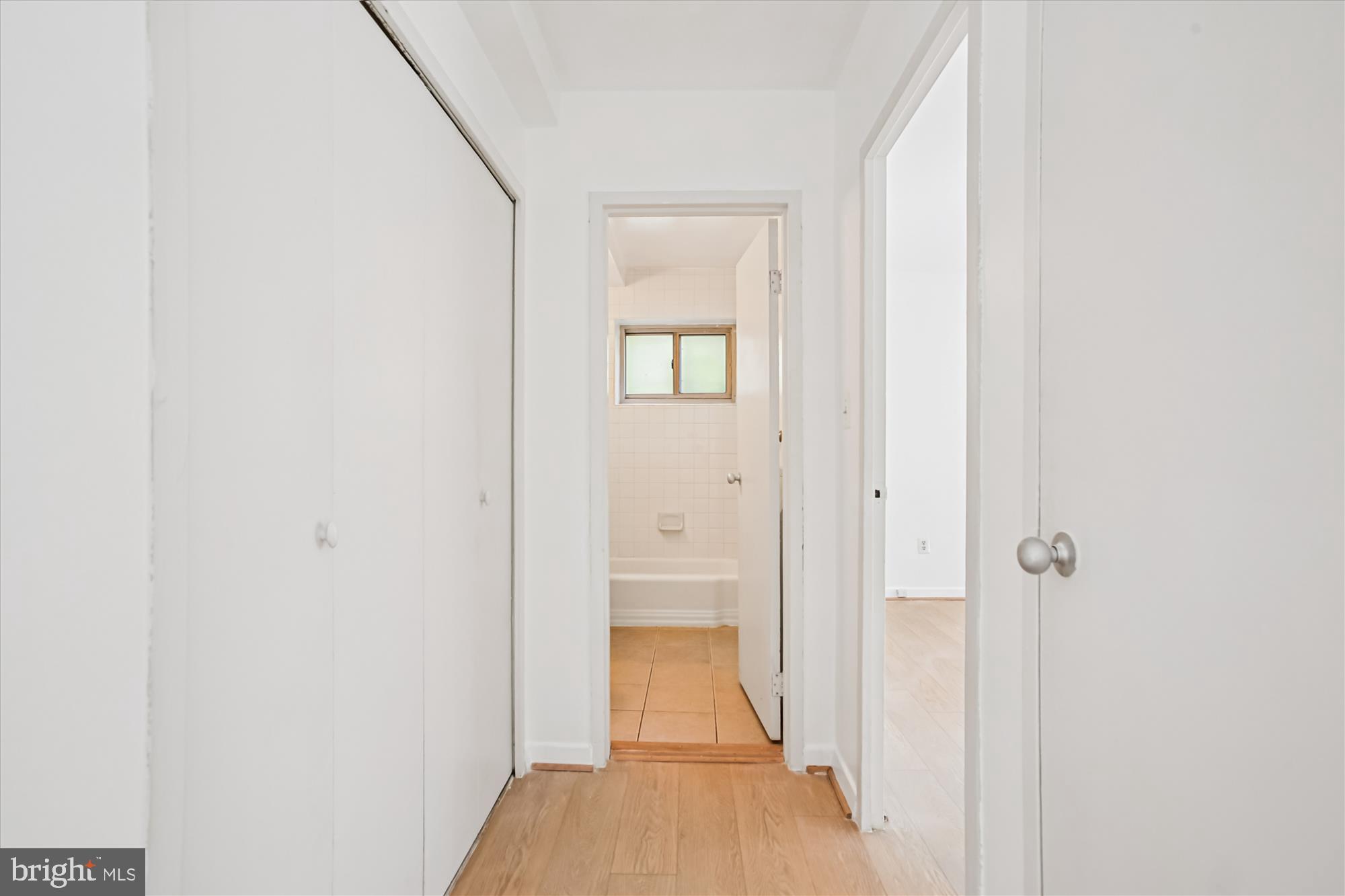 3900 Tunlaw Road Northwest, Unit 509 Washington, DC 20007 - Photo 16 of 36 a view of a bathroom from a hallway