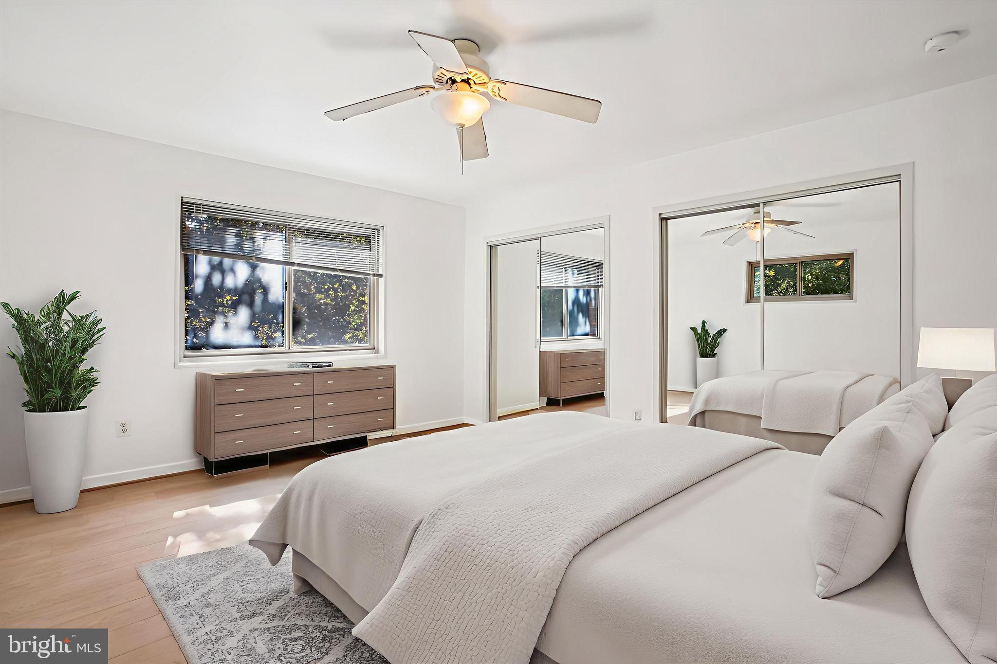 3900 Tunlaw Road Northwest, Unit 509 Washington, DC 20007 - Photo 17 of 36 a bedroom with a bed dresser and a window