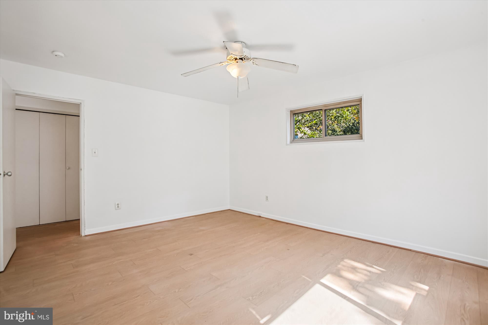 3900 Tunlaw Road Northwest, Unit 509 Washington, DC 20007 - Photo 18 of 36 an empty room with a ceiling fan and a window