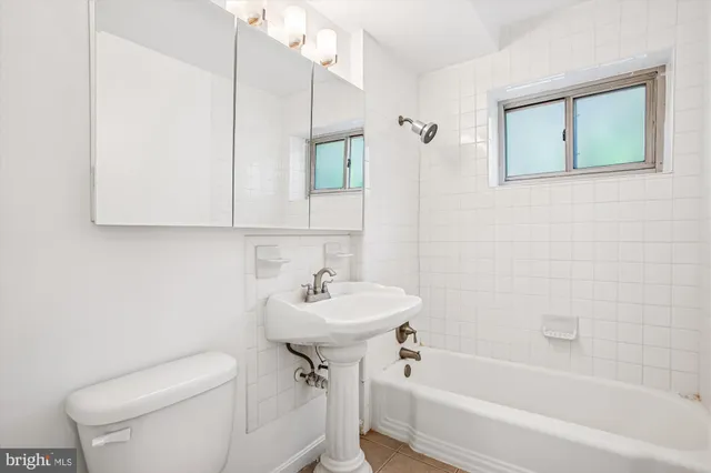 a bathroom with a sink a toilet and bathtub