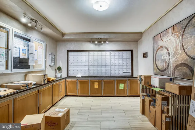 a large kitchen with stainless steel appliances a large counter top a stove a chimney a sink and a large window