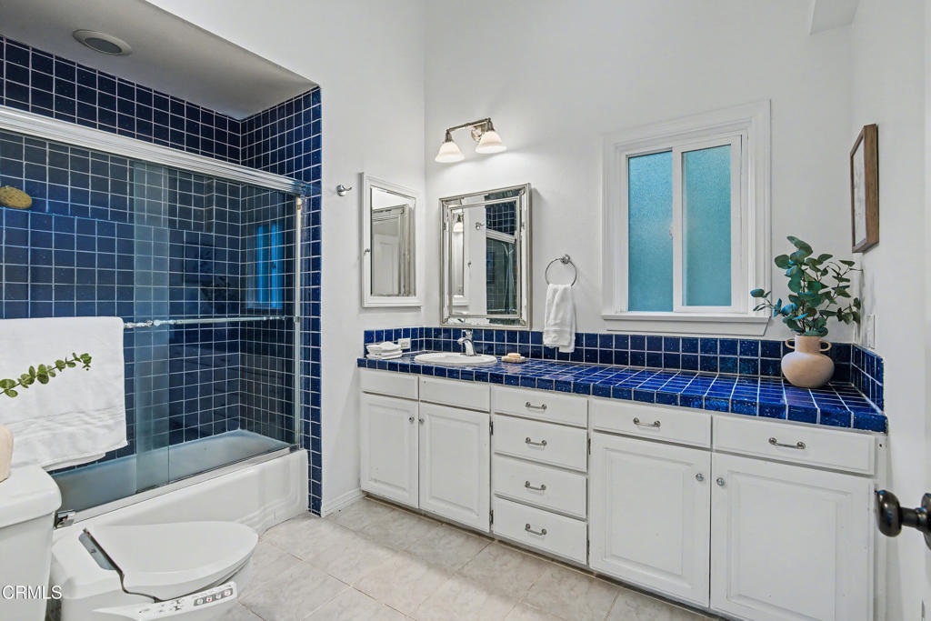 640 Chaparral Road Sierra Madre, CA 91024 - Photo 14 of 25 a bathroom with a double vanity sink a toilet and bathtub