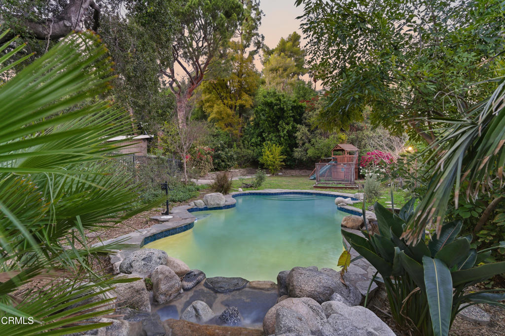 640 Chaparral Road Sierra Madre, CA 91024 - Photo 21 of 25 a view of a backyard with plants and a lake view