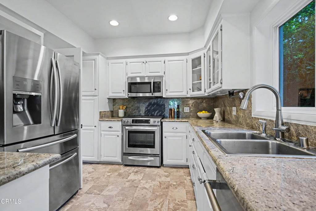640 Chaparral Road Sierra Madre, CA 91024 - Photo 6 of 25 a kitchen with granite countertop a sink stainless steel appliances and cabinets