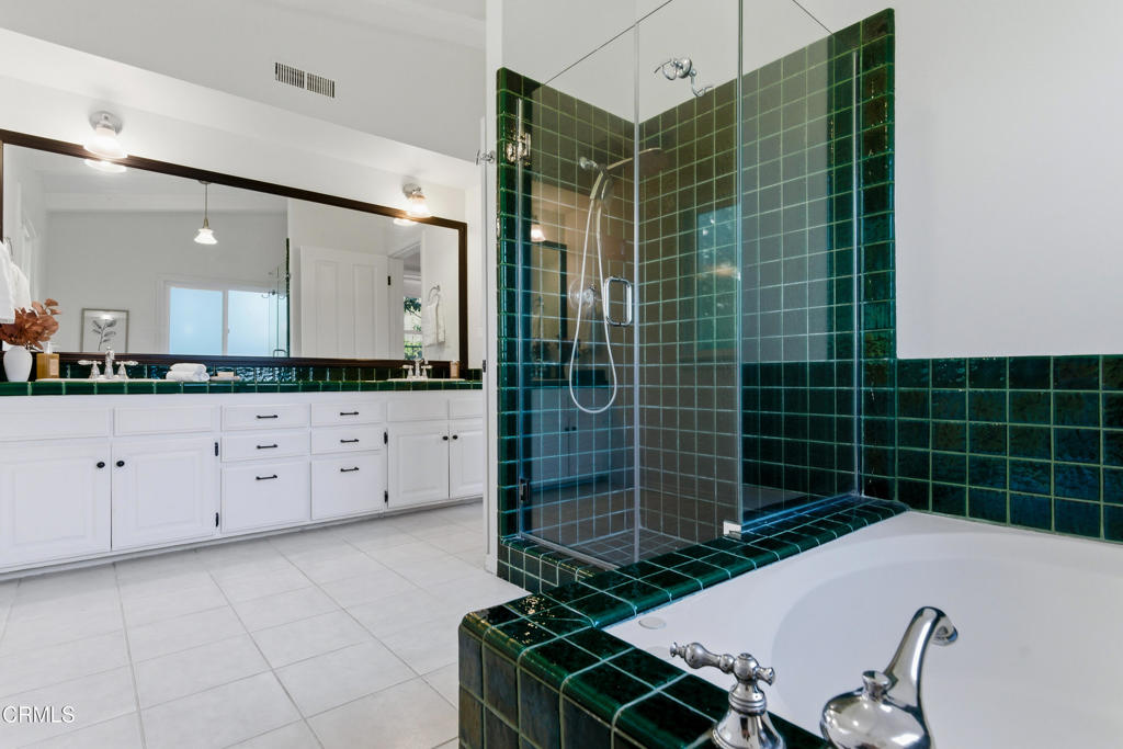 640 Chaparral Road Sierra Madre, CA 91024 - Photo 10 of 25 a bathroom with a granite countertop sink a vanity and a blue shower