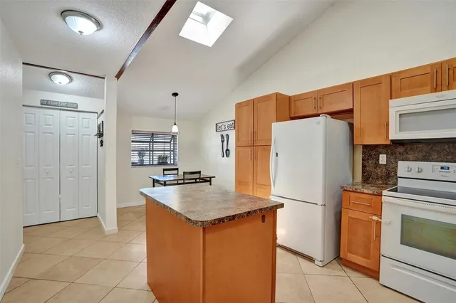 a kitchen with refrigerator and cabinets