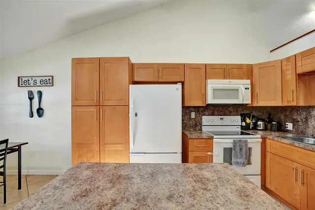 a kitchen with stainless steel appliances a refrigerator sink and cabinets