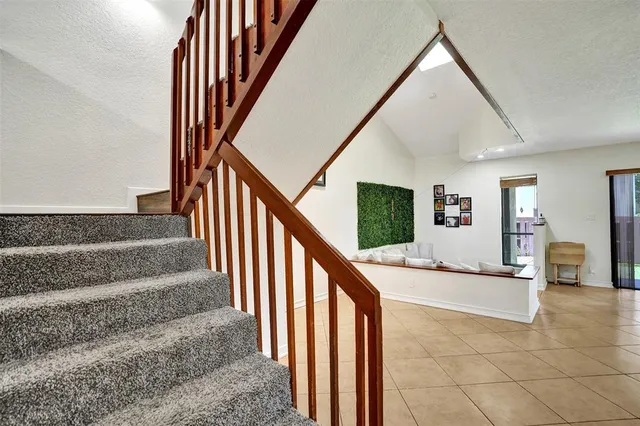 a view of staircase with railing and white walls