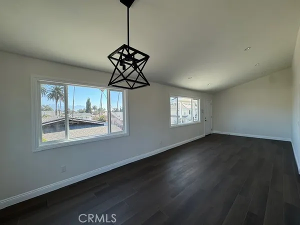 a view of an room with window and wooden floor
