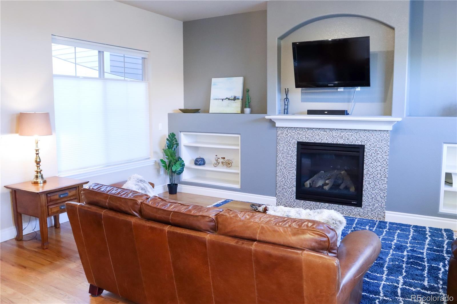 9242 Ridgegate Parkway Lone Tree, CO 80124 - Photo 5 of 28 a living room with furniture and a flat screen tv