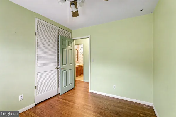 a view of empty room with wooden floor
