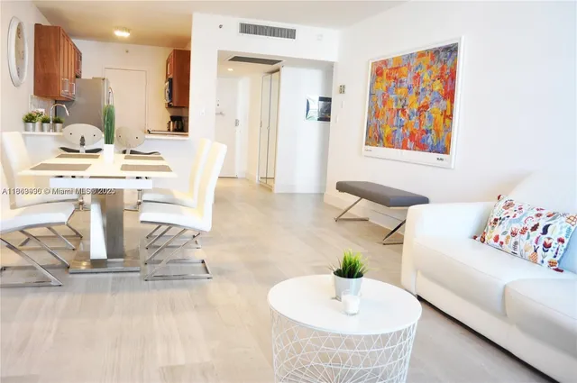 a living room with kitchen island furniture and a wooden floor