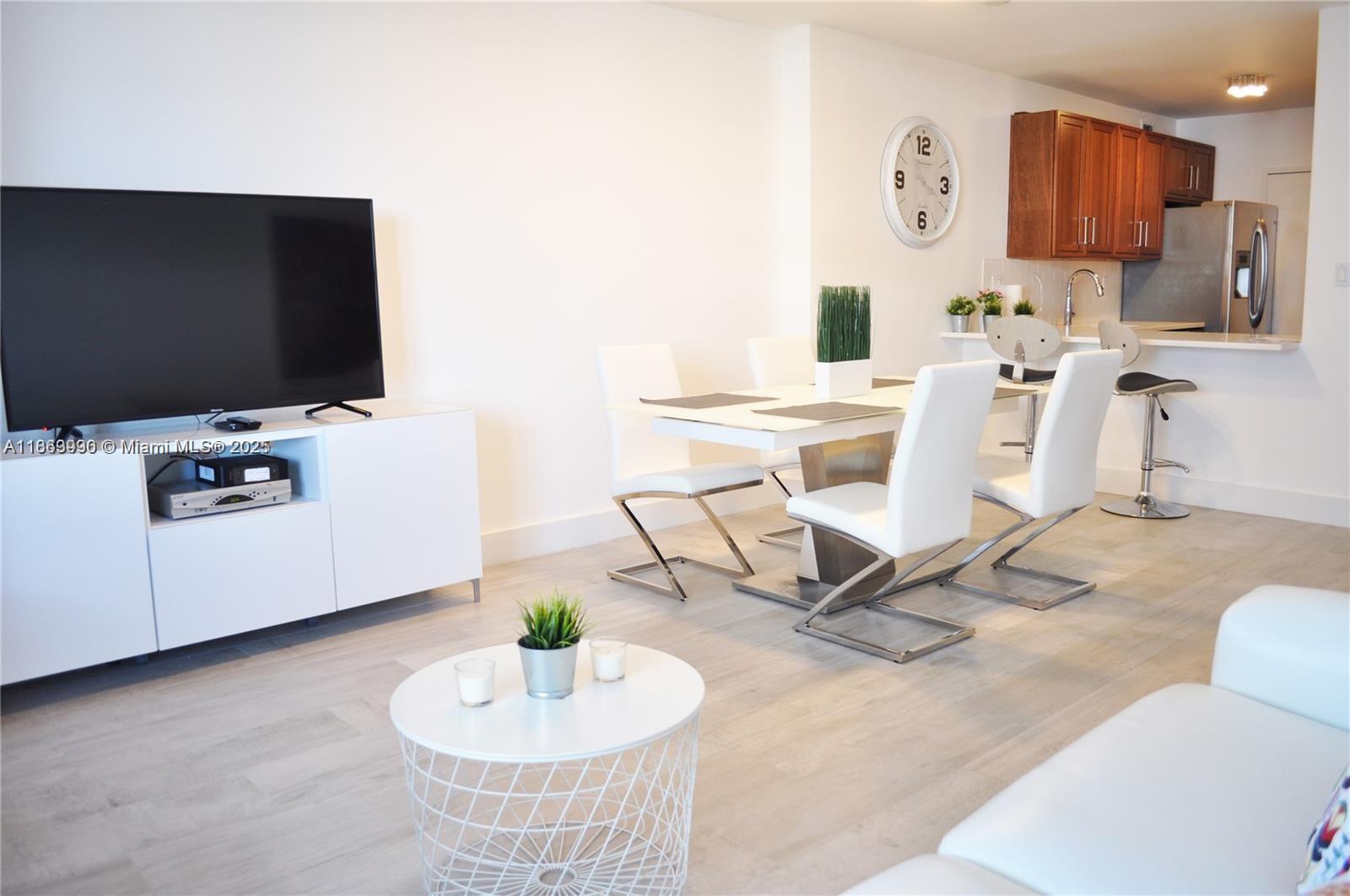 100 Lincoln Road, Unit 435 Miami Beach, FL 33139 - Photo 4 of 9 a living room with furniture and a flat screen tv