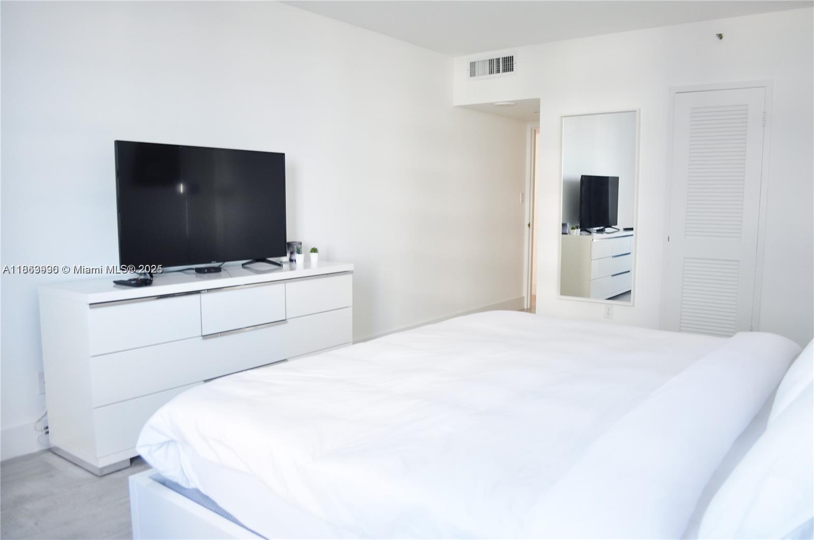 100 Lincoln Road, Unit 435 Miami Beach, FL 33139 - Photo 6 of 9 a bedroom with a bed and a flat screen tv