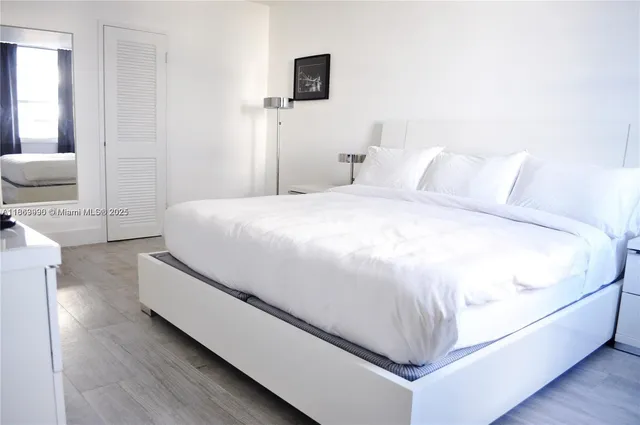 a spacious bedroom with a bed and a couch