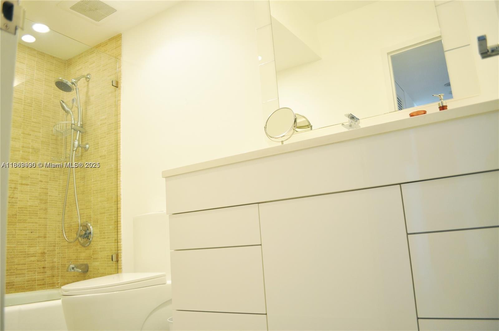 100 Lincoln Road, Unit 435 Miami Beach, FL 33139 - Photo 8 of 9 a bathroom with a tub and shower