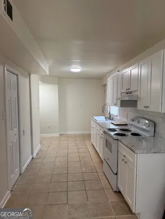 a kitchen with a sink cabinets and appliances