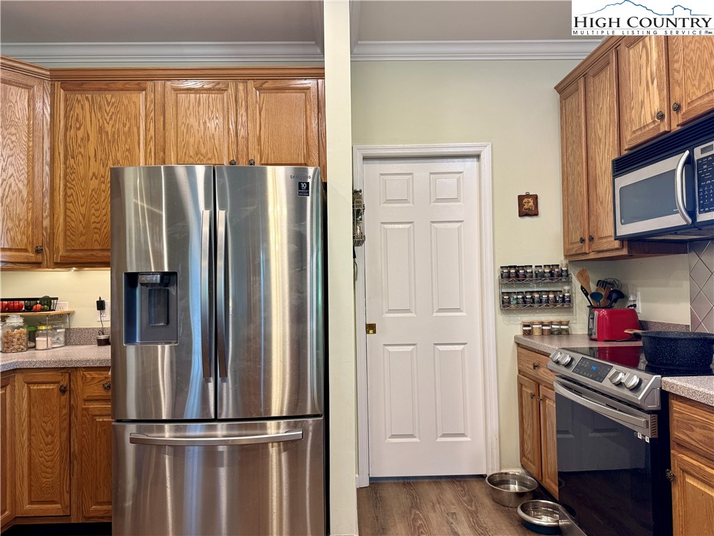 449 Meadow Ridge Drive Jefferson, NC 28640 - Photo 14 of 40 a kitchen with stainless steel appliances granite countertop a refrigerator stove and a window