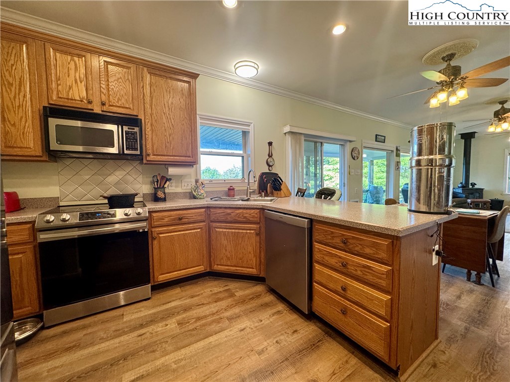 449 Meadow Ridge Drive Jefferson, NC 28640 - Photo 15 of 40 a kitchen with stainless steel appliances granite countertop a stove and a sink