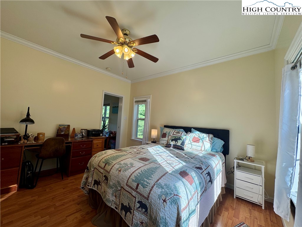 449 Meadow Ridge Drive Jefferson, NC 28640 - Photo 19 of 40 a bedroom with a bed and wooden floor