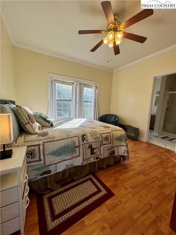 449 Meadow Ridge Drive Jefferson, NC 28640 - Photo 20 of 40 a bedroom with a bed and a chandelier