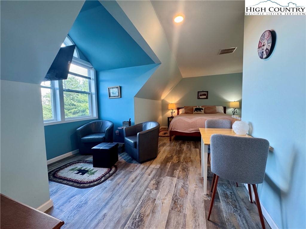 449 Meadow Ridge Drive Jefferson, NC 28640 - Photo 29 of 40 a living room with furniture and a wooden floor