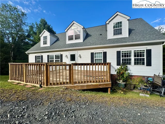a backyard of a house with deck and furniture