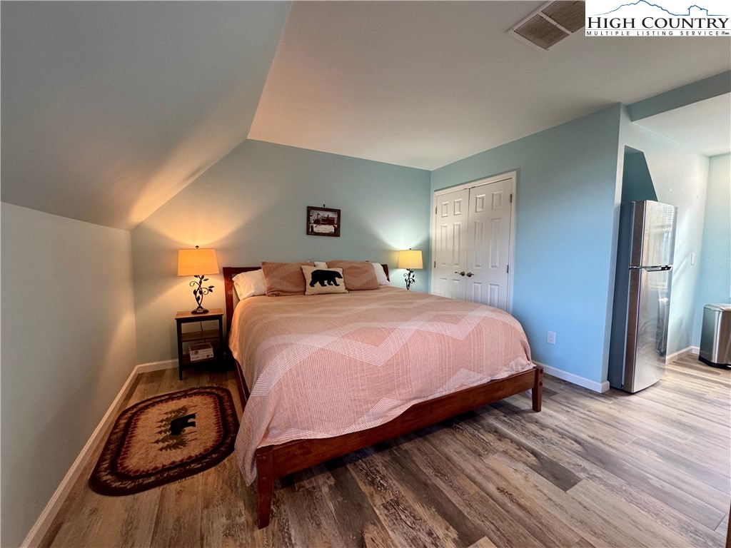 449 Meadow Ridge Drive Jefferson, NC 28640 - Photo 32 of 40 a bedroom with a bed and wooden floor