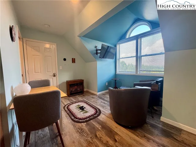 a view of a chairs and table in patio with wooden floor