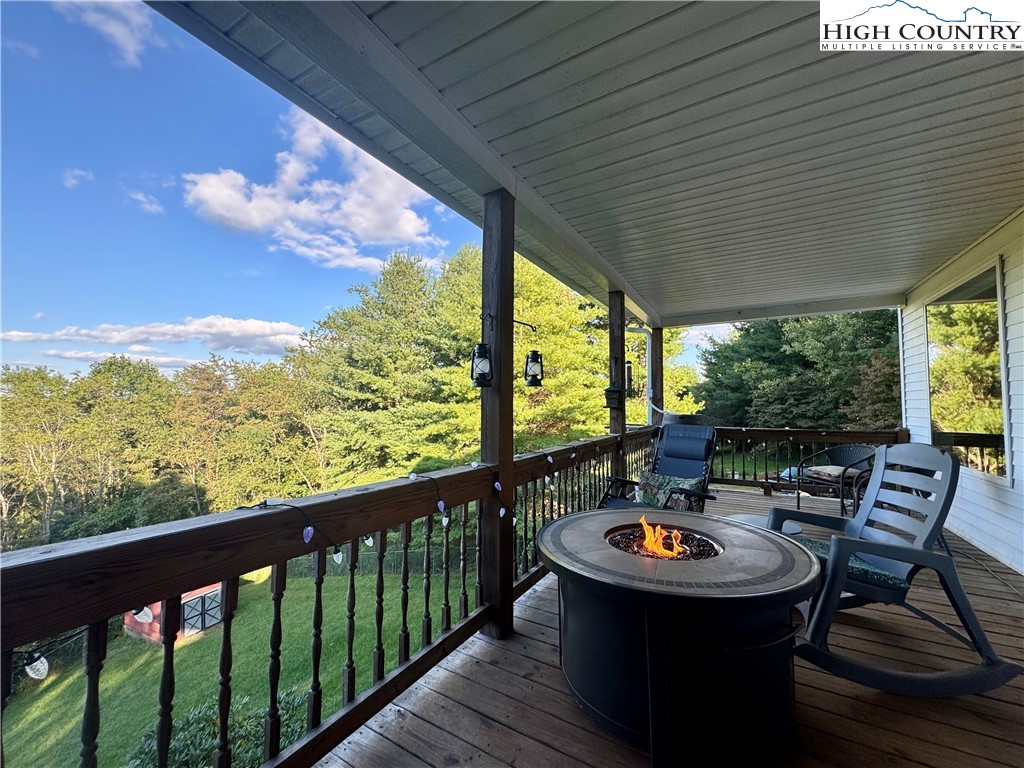 449 Meadow Ridge Drive Jefferson, NC 28640 - Photo 36 of 40 a view of a chairs and table in patio with wooden floor