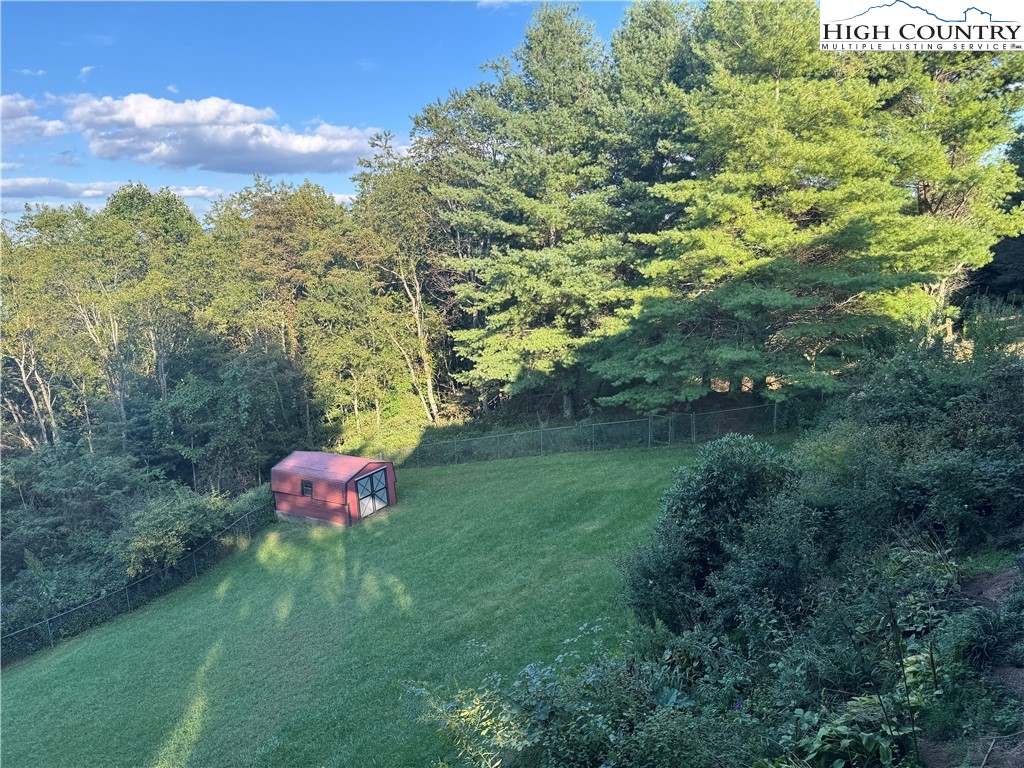 449 Meadow Ridge Drive Jefferson, NC 28640 - Photo 38 of 40 a view of a yard with a bench