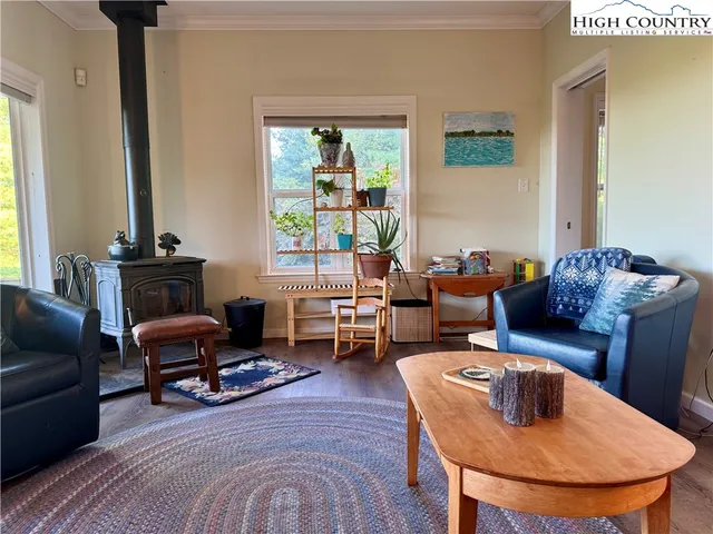 a living room with furniture and a floor to ceiling window