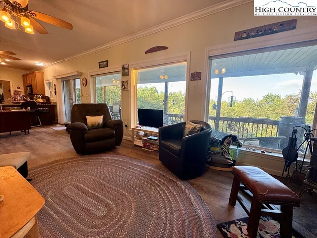 a living room with furniture and a floor to ceiling window